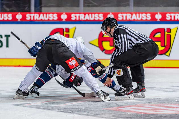 Linesman Marius Woelzmueller Conducts A Faceoff Between Markus