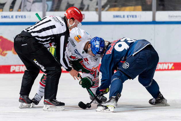 Linesman Marius Woelzmueller Conducts A Faceoff Between Markus