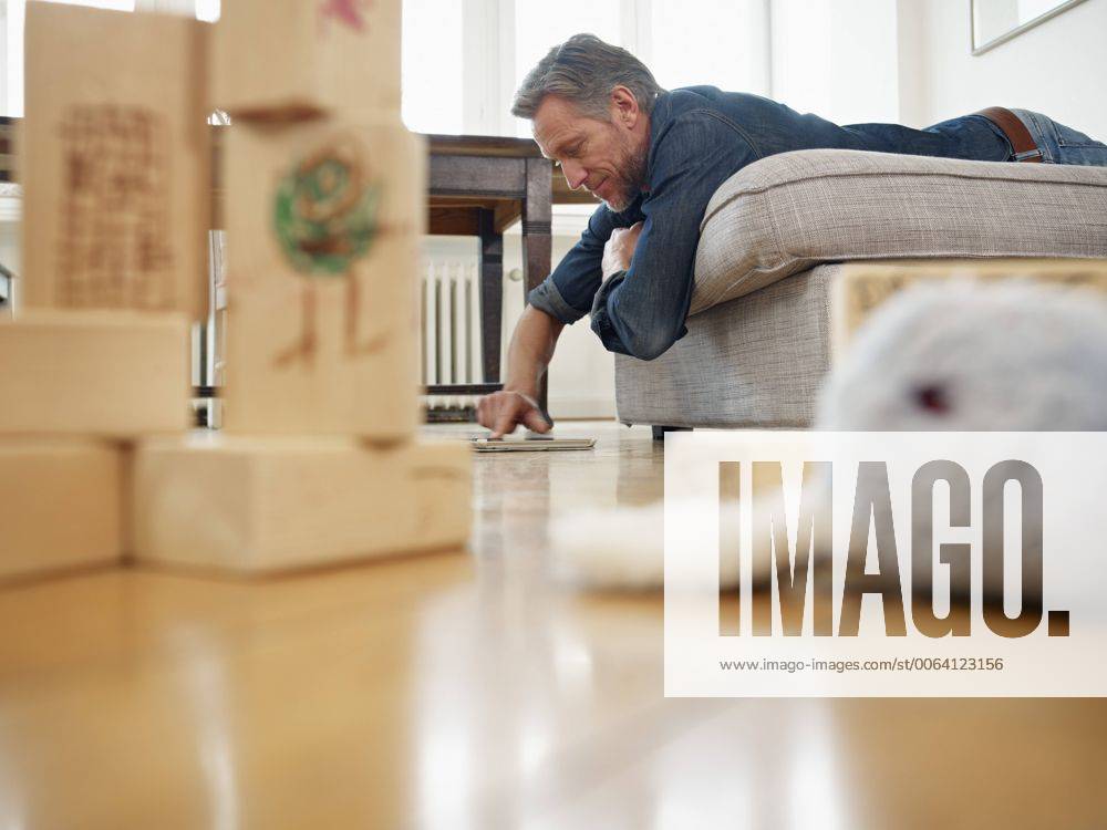 Mature Man Lying On Sofa Using Digital Tablet Model Released Symbolfoto