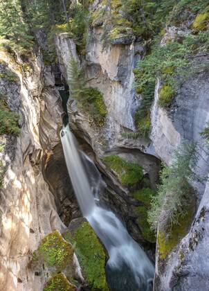 Waterfall In A Gorge Maligne Canyon Wild River Flowing Through Gorge