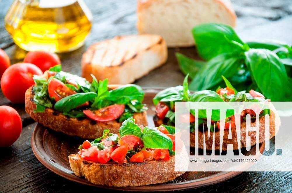 Italian Bruschetta With Chopped Vegetables Herbs And Oil On Grilled Or