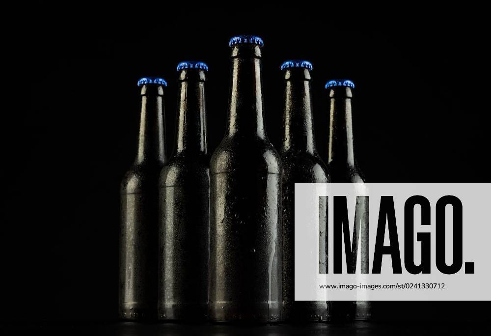 Image Of Five Beer Bottles With Blue Crown Caps With Copy Space On