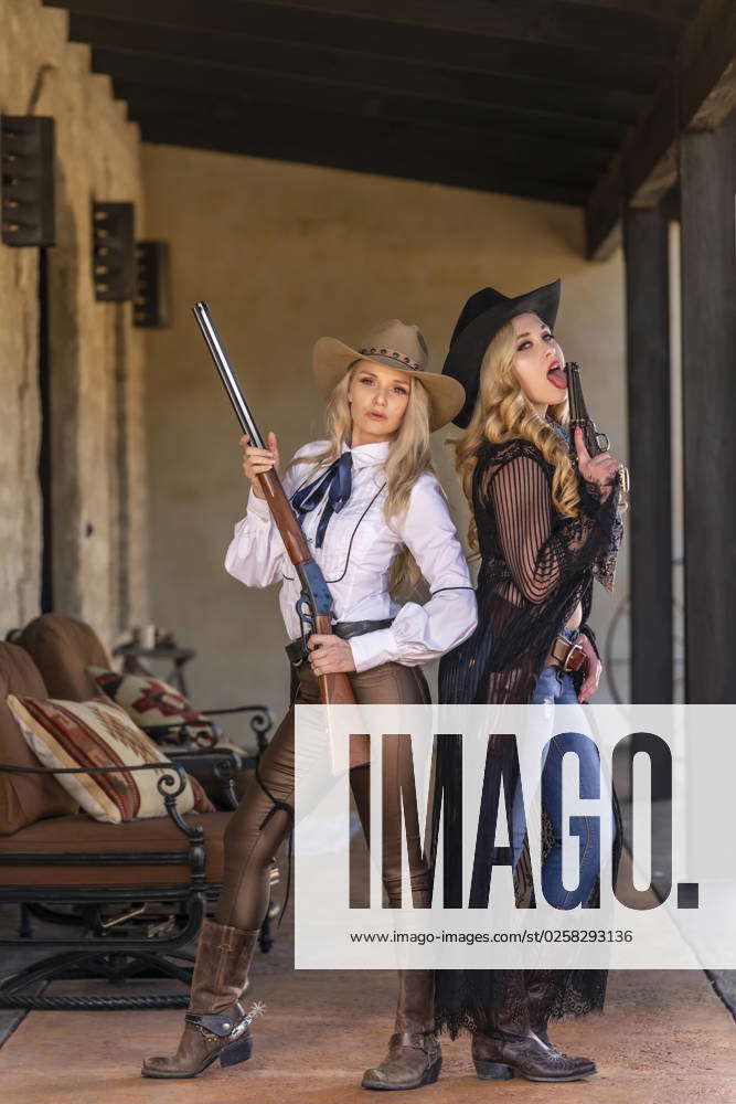 Two Lovely Blonde Models Dressed As Cowgirls Enjoys The American West