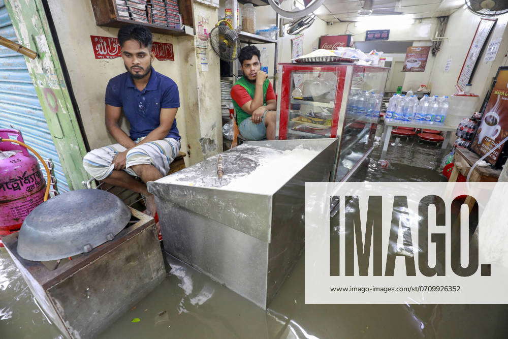 Flooding Bangladesh Commuters Wade Through A Waterlogged Road After