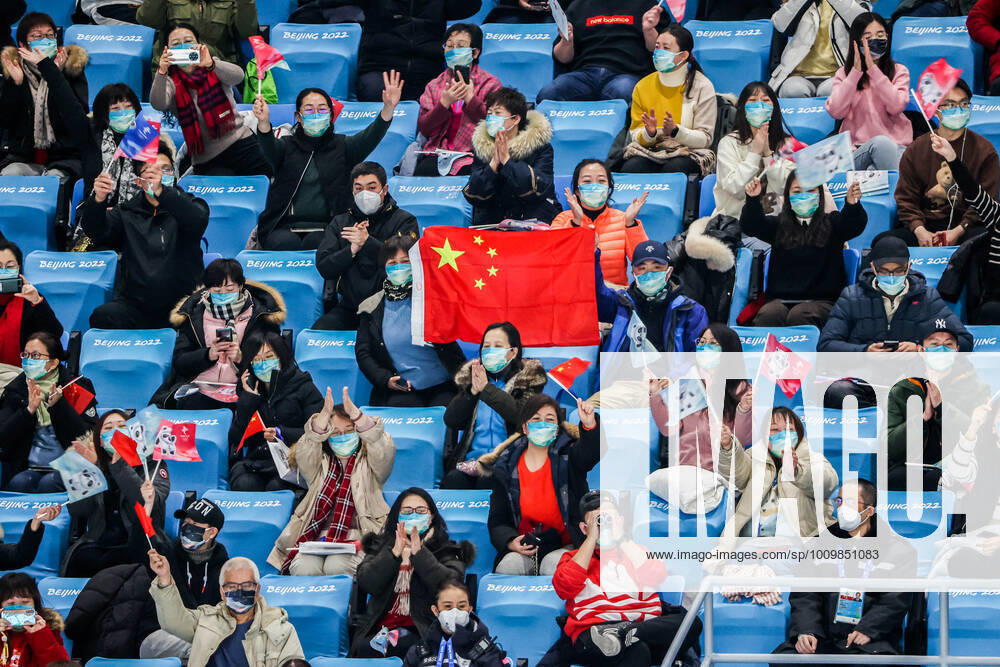 BEIJING, CHINA â€“ FEBRUARY 14, 2022: Spectators wave a Chinese national flag as they watch the free dance event as part of the Figure skating, Eiskunstlauf competition at the Beijing 2022 Winter Olympic Games, Olympische Spiele, Olympia, OS at the Capital Indoor Stadium. Valery Sharifulin TASS TS122FCB