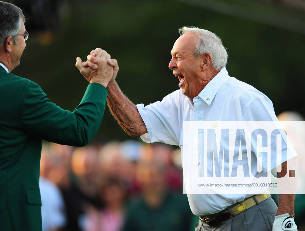 Augusta, GA, USA - Arnold Palmer turns and slaps hands with Billy Payne (left), chairman of Augusta National Golf Club following Palmer s drive from the 1st tee as part of the 1st tee ceremonial drive at Augusta National Golf Club in Augusta, Georgia on Thursday, April 5, 2012. First day of The Masters - ZUMAm67