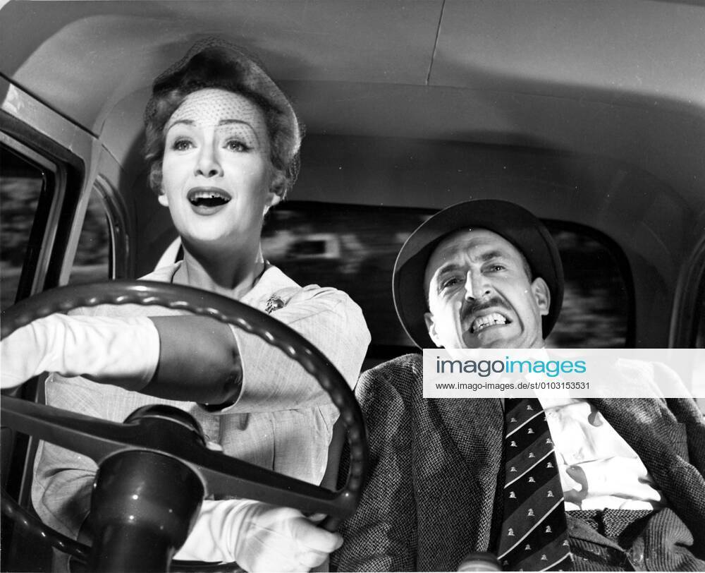PLEASE TURN OVER ANGLO-AMALGAMATED PRODUCTIONS JEAN KENT, LIONEL JEFFRIES women driving bad. Strictly editorial use only in conjunction with the promotion of the film. Credit line mandatory. This image is copyright of the film company and is supplied under the terms of issue as film still. No commercial or book cover use permitted without prior consent from the film company. Mandatory credit line: Image courtesy Ronald Grant Archive Mary Evans