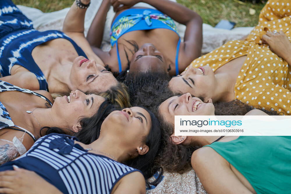IMAGO Creative, Jahreszeit Sommer, Sommerferien Group of smiling female friends laying on a towel in a park having fun Elcarte, Navarra, Spain CR_SEBO201027B-529243-01 ,model released, Symbolfoto