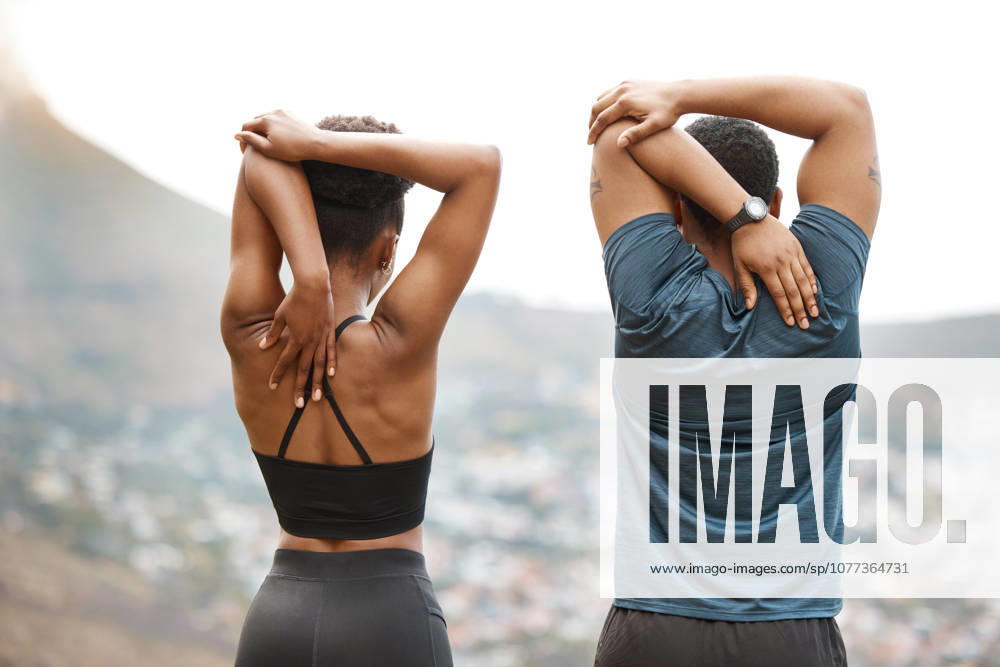 Couple, stretching and arm warm up for exercise, fitness and race training outdoor with back. group and wellness with start and hill at sunrise with workout and relax morning with city view. (License=RF) 21850742 ,model released, Symbolfoto