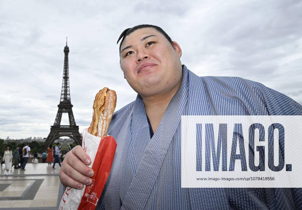 Sumo: Paris tournament Sumo grand champion Onosato is pictured with a baguette while sightseeing around Paris landmark Eiffel Tower on June 11, 2026, ahead of a June 13-14 sumo tournament in the French capital. A14AA0005618477P