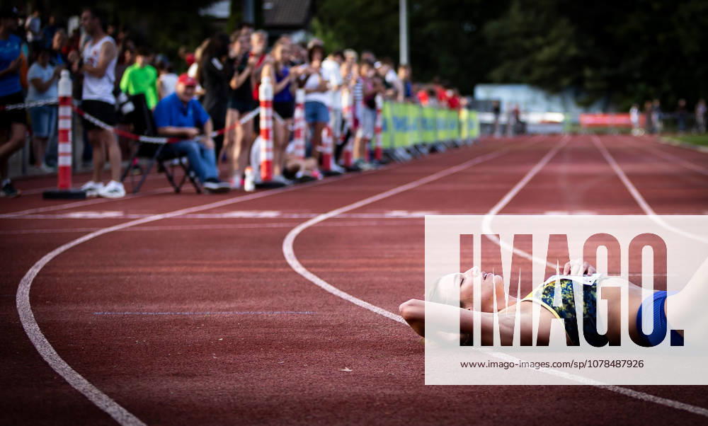 Merck Laufgala Pfungstadt, 13 06 2026 Exhausted Lara Tortell GER Athletics Team Karben lies behind the finish line after her 800m race on the Merck Laufgala tartan track on 13 06 2026 at the TSV Stadium in Pfungstadt, Hesse