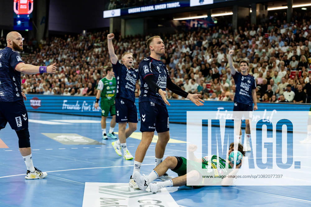 Opel HBL SG Flensburg Handewitt vs. ThSV Eisenach, August 28, 2026: Stephan Seitz, No. 44, ThSV Eisenach on the floor, Simon Pytlick No. 02, SG Flensburg Handewitt gesturing; Opel HBL SG Flensburg Handewitt vs. ThSV Eisenach, GGW Arena on August 28, 2026