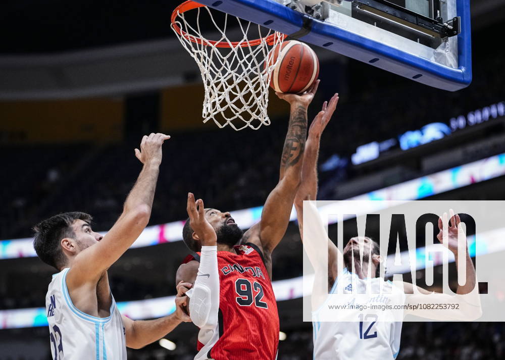 Canada s Khem Birch (92) goes to the net under pressure from Argentina s Gonzalo Bressan (18) and teammate Leandro Bolmaro (12) during their FIBA world cup qualification action in Quebec City, Monday, Aug.Ã‚ 31, 2026. Khem Birch (92) Leandro Bolmaro (12) - ZUMAc35_ 20260831_zaf_c35_080