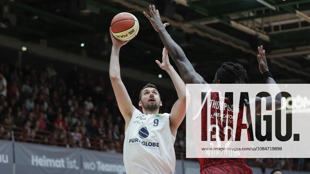 Pictured, from left: Kresimir Nikic of Syntainics MBC, No. 9, making a layup against Charles Thompson of Wuerzburg Baskets, No. 32 (18 10 2026), Fitness First Wuerzburg Baskets vs. SYNTAINICS MBC, Netto BBL Cup, Round of 16, Germany, 97072, tectake Arena Wuerzburg,