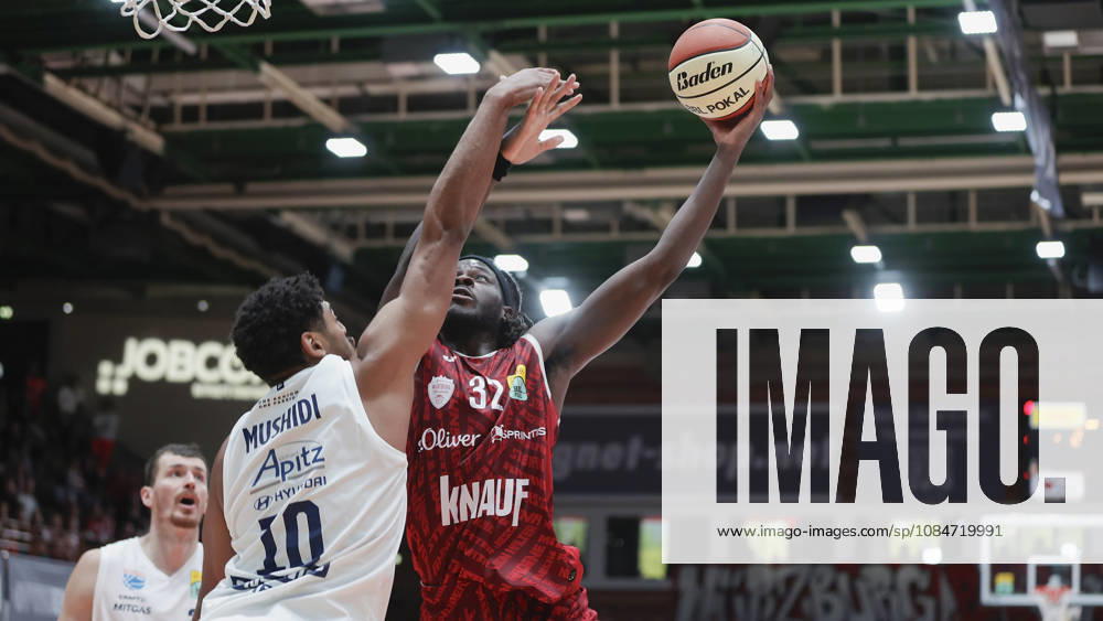 Pictured from left: Kostja Mushidi of Syntainics MBC, No. 10, against Charles Thompson of Wuerzburg Baskets, No. 32, making a layup on 18 October 2026, Fitness First Würzburg Baskets vs. SYNTAINICS MBC, Netto BBL Cup, Round of 16, Germany, 97072, tectake Arena Würzburg,