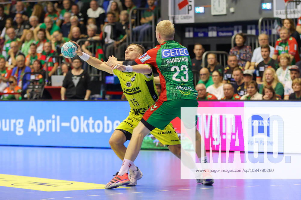 Handball Opel HBL SC Magdeburg vs. TVB Stuttgart, from left: Simone Mengon (Stuttgart), 15, Magnus Saugstrup (Magdeburg), 23; duel, battle, tackle, Magdeburg