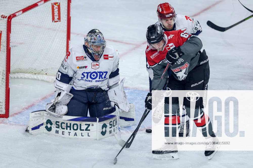 Ice hockey, DEL, Kölner Haie vs. Schwenninger Wild Wings, Matchday 49, 2026–27 season, Lanxess Arena, Cologne; Joacim Eriksson (SWW) 60 defends against Patrick Russell (Kölner Haie) 63; North Rhine-Westphalia, Germany