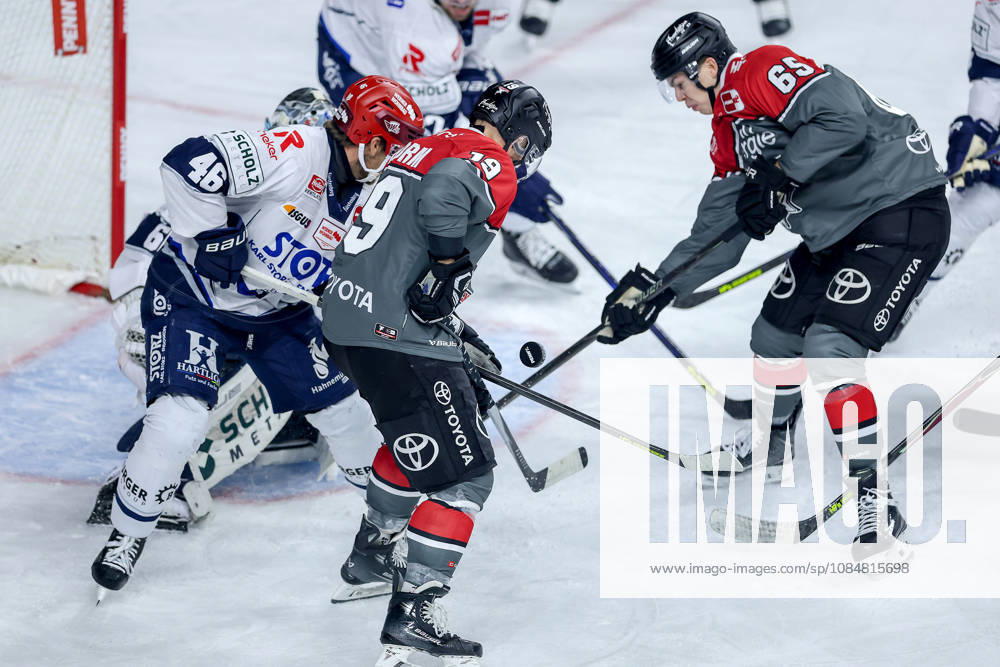Ice Hockey, DEL, Kölner Haie vs. Schwenninger Wild Wings, Matchday 49, 2026–27 Season, Lanxess Arena, Cologne: Frederik Storm of the Kölner Haie (No. 19) attacks the goal defended by Joacim Eriksson of the SWW (No. 60) alongside Marco Münzenberger of the Kölner Haie (No. 65), North Rhine-Westphalia, Germany