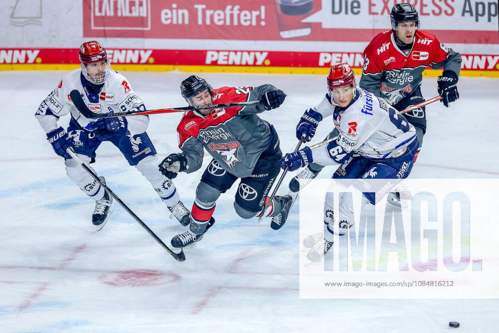 Ice Hockey, DEL, Kölner Haie vs. Schwenninger Wild Wings, Matchday 49, 2026–27 Season, Lanxess Arena, Cologne; Tim Fleischer (Cologne Sharks, No. 29) in a battle against Alex Trivellato (SWW, No. 53) and Boaz Bassen (SWW, No. 64); North Rhine-Westphalia, Germany