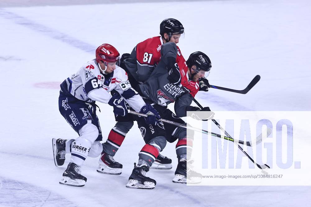 Boaz Bassen of the Schwenninger Wild Wings, No. 64, in a one-on-one battle with Mateu Spaeth of the Koelner Haie, 81, center, and Frederik Storm of the Cologne Sharks, 19 GER, Cologne Sharks vs. Schwenninger Wild Wings, ice hockey, Penny DEL, Matchday 49, 2026–2027 season, October 20, 2026, GER, Cologne Sharks vs. Schwenninger Wild Wings, Ice Hockey, Penny DEL, Matchday 49, 2026–2027 season, October 20, 2026, Cologne