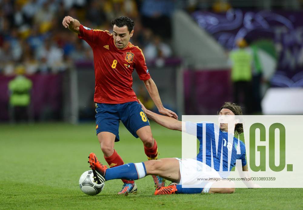 Xavi (L) of Spain vies with Riccardo Montolivo of Italy during the final match between Italy and Spain at the Euro 2012 football championships in Kiev, Ukraine, July 1, 2012. (Xinhua Ma Ning) (jyc) UKRAINE-KIEV-EURO 2012 FOOTBALL CHAMPIONSHIPS-FINAL