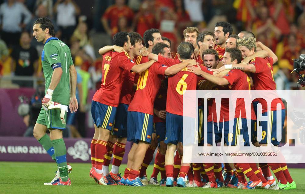 Players of Spain celebrate victory after the final match between Italy and Spain at the Euro 2012, L- Gianluigi Buffon - football championships in Kiev, Ukraine, July 1, 2012. Spain won 4-0 to claim the title. -