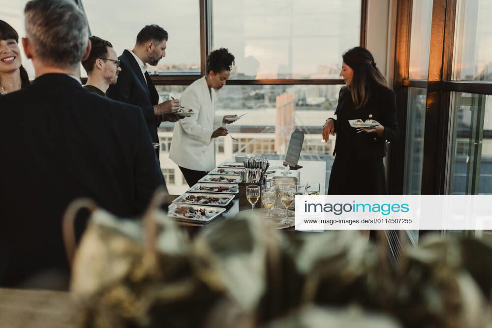 Smiling business people having during office party Sweden, Stockholm, model released, property released