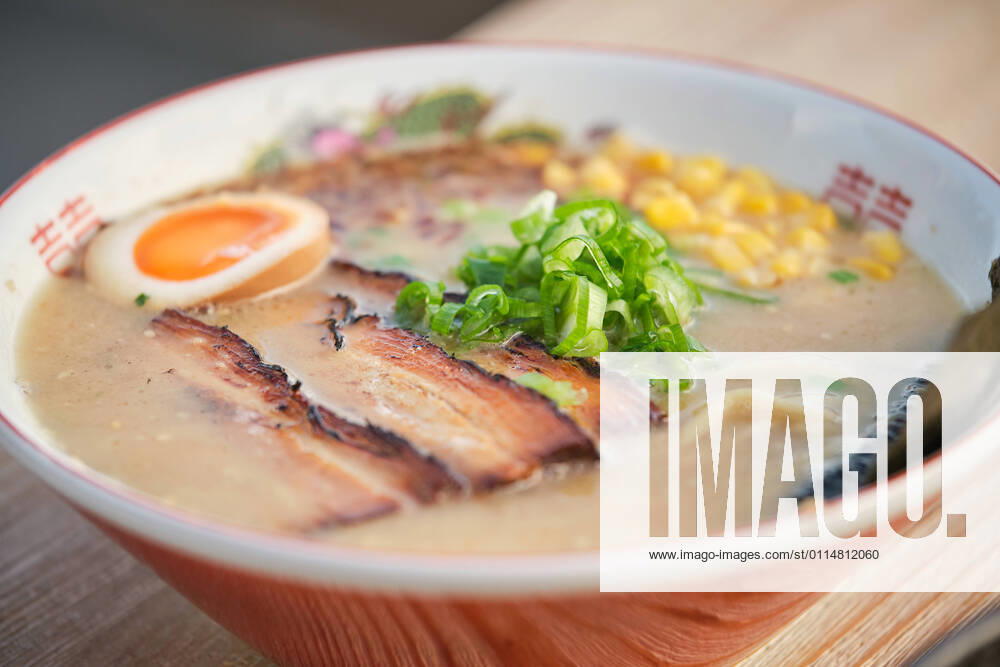 Stock photo of yummy ramen soup with boiled egg and meat in japanese restaurant ready to be served., Model released