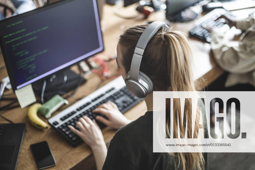 High angle view of female programmer working at startup company Sweden, Stockholm, model released, property released