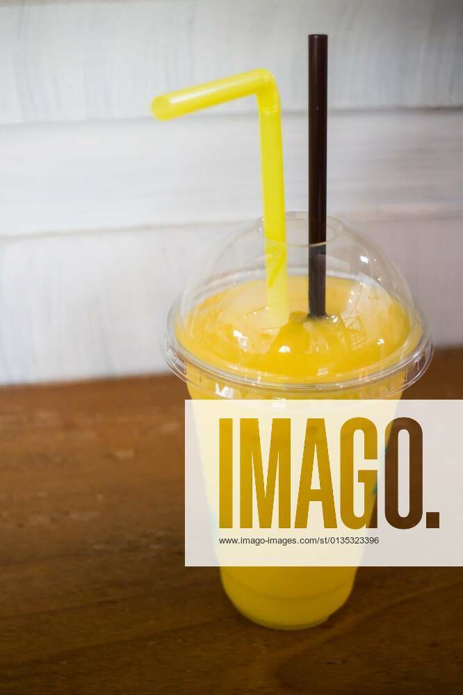 Delicious mango smoothies on wooden table, 12.10.2020,
