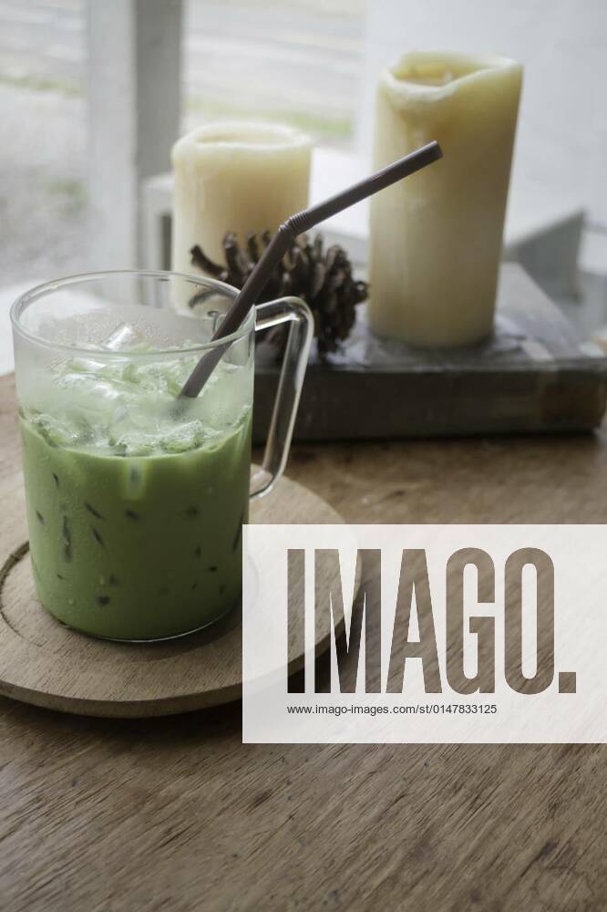 Iced green tea latte on wooden table, 12.10.2020,