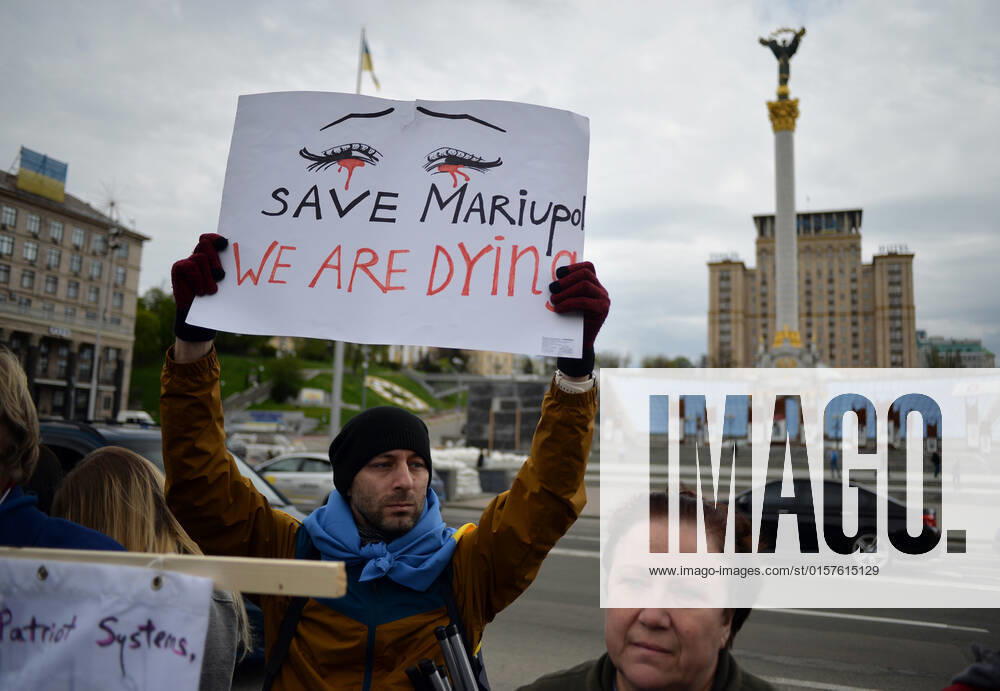 KYIV, UKRAINE - APRIL 30, 2022 - A man holds a placard in Maidan Nezalezhnosti as part of a rally in support of Mariupol defenders during which the relatives of Ukrainian soldiers have called upon the world leaders to ensure a green corridor and the evacuation from the Azovstal plant in Mariupol, Donetsk Region, Kyiv, capital of Ukraine. Rally in support of Mariupol defenders in Kyiv