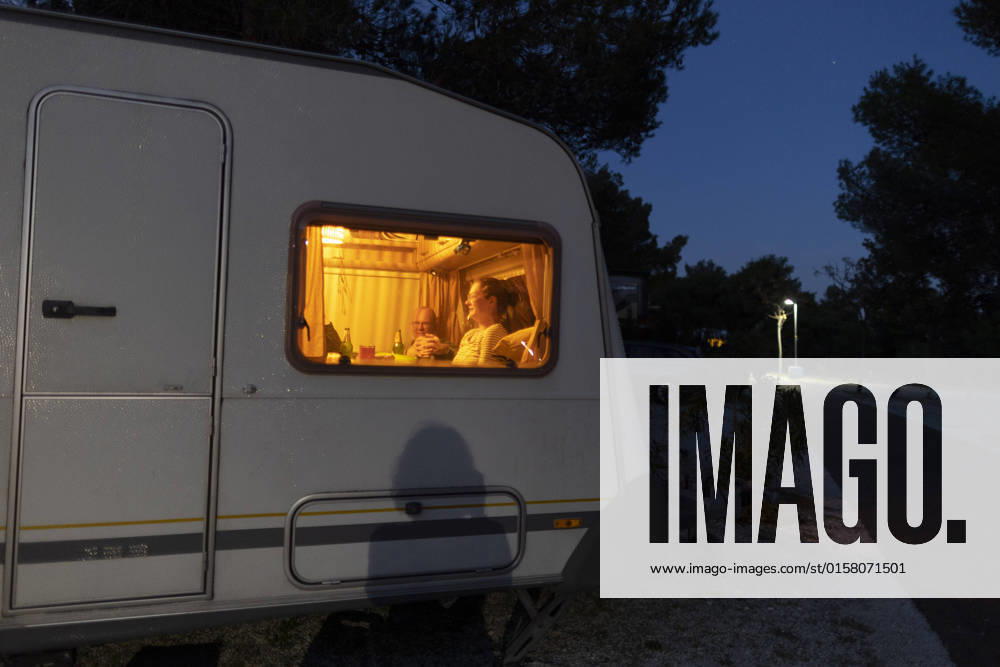 Man and woman sitting in caravan at night Seget Vranjica Croatia