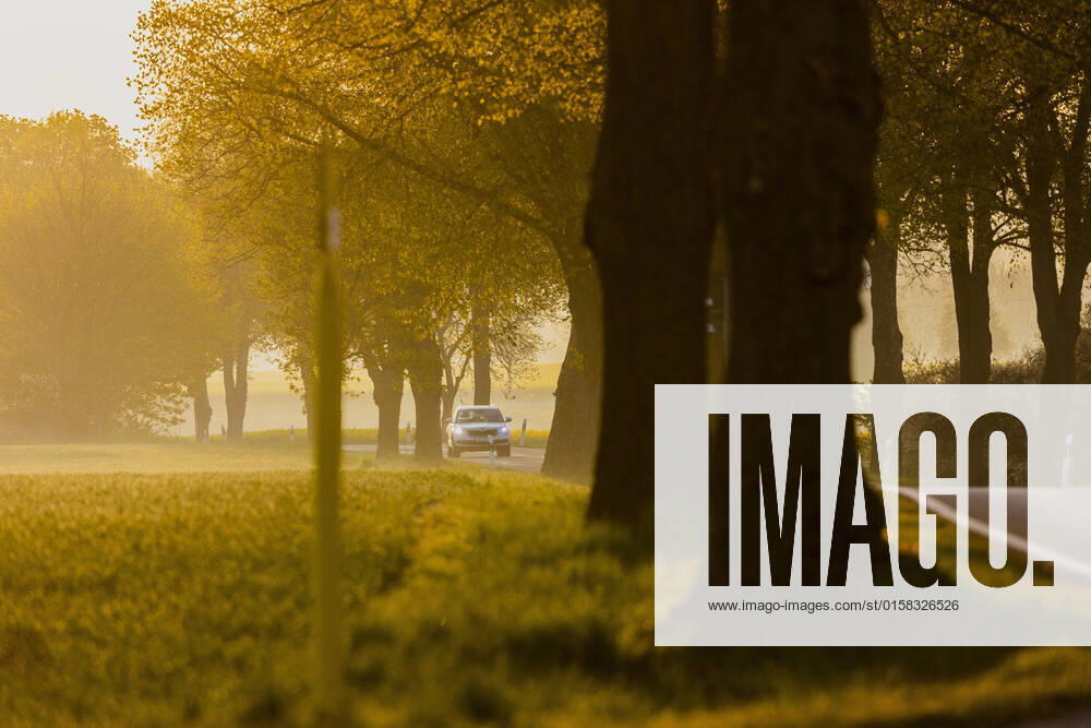 A car drives over a country road in the morning light in Glasewitz, 05 05 2022 Glasewitz Germany