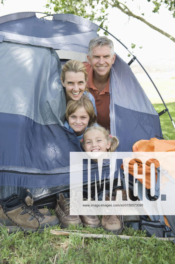 Family of four smiling from a tent, model released, , property released, , 10124486.jpg, Outdoors,Day,Fun,Smiling,people,Family,Togetherness,Happiness,Mother,Children,Parents,leisure activity,Camping,Backpack,Footwear,Caucasian,outside,Tent,Looking At Camera,camping equipment,four people,Human Head,Family Holiday,Activity Holiday,Walking Boots,Adventure Holiday,Outdoor Activity,family vacation,Camping Pitch,Tent Flap, California