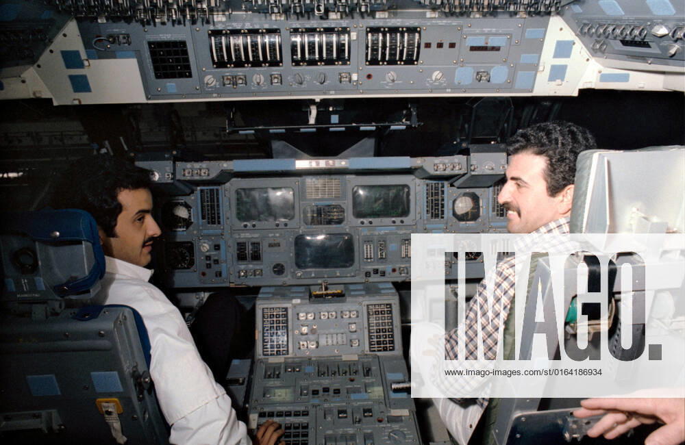 S85-29788 (May 1985) --- Sultan Salman Abdelazize Al-Saud and Abdulmohsen Hamad Al-Bassam man the controls on the flight deck of the crew compartment trainer (CCT) in the Shuttle mockup and integration laboratory at the Johnson Space Center (JSC).