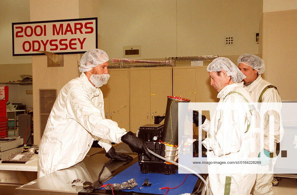 In the Spacecraft Assembly and Encapsulation Facility 2, workers test the Thermal Emission Imaging System (THEMIS) before attaching to the 2001 Mars Odyssey Orbiter. THEMIS will map the mineralogy and morphology of the Martian surface using a high-resolution camera and a thermal infrared imaging spectrometer. The orbiter will carry three science instruments: THEMIS, the Gamma Ray Spectrometer (GRS), and the Mars Radiation Environment Experiment (MARIE). The GRS will achieve global mapping of the elemental composition of the surface and determine the abundance of hydrogen in the shallow subsurface. The MARIE will characterize aspects of the near-space radiation environment with regards to the radiation-related risk to human explorers. The Ma