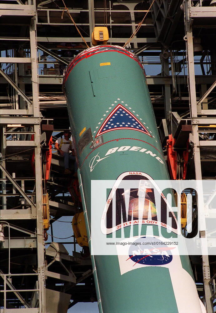 The first stage of a Boeing Delta rocket is lifted into place in the gantry on Launch Pad 17-A, Cape Canaveral Air Force Station. The rocket will carry the 2001 Mars Odyssey Orbiter, scheduled for launch April 7, 2001. Mars Odyssey contains three science instruments: THEMIS, the Gamma Ray Spectrometer (GRS), and the Mars Radiation Environment Experiment (MARIE). THEMIS will map the mineralogy and morphology of the Martian surface using a high-resolution camera and a thermal infrared imaging spectrometer. The GRS will achieve global mapping of the elemental composition of the surface and determine the abundance of hydrogen in the shallow subsurface. The MARIE will characterize aspects of the near-space radiation environment with regards to t