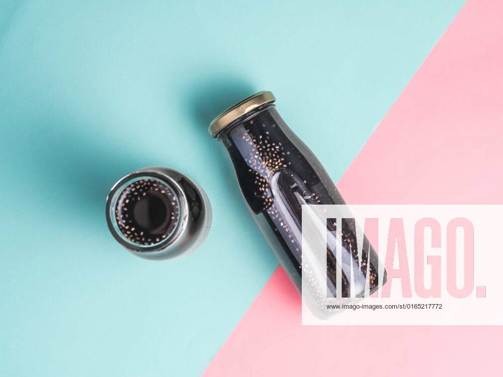 Detox activated charcoal black chia water, Detox activated charcoal black chia water or mocktail on colorful blue and pink background.Two bottle with black chia infused water.Detox drink idea and recipe.Vegan food and drink.Top view, Detox activated charcoal black chia water or mocktail on colorful blue and pink background.Two bottle with black chia infused water.Detox drink idea and recipe.Vegan food and drink.Top view, 24.11.2020,