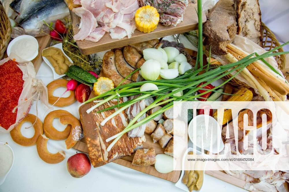 Meat charcuterie board with pickled vegetables and mustard. Bread, sauces, spices for meat delicacies, Fish and meat snacks on a festive table with spices and sauces. Meat, bread and snacks, Fish and meat snacks on a festive table with spices and sauces. Meat, bread and snacks, 31.01.2021,