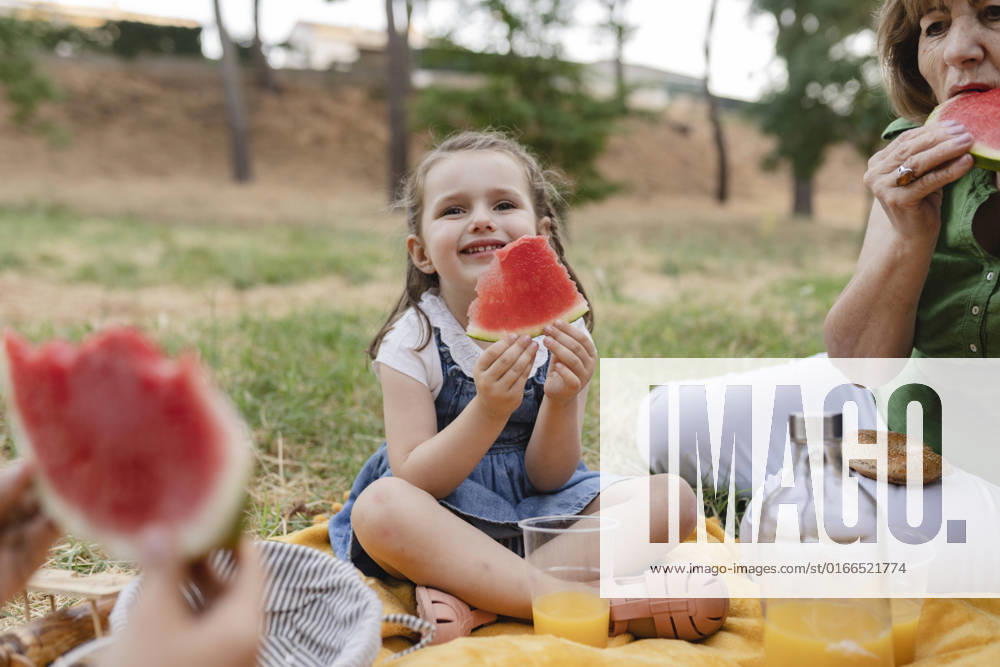 Cute girl holding watermelon sitting by grandmother model released, Symbolfoto, JCCMF06839