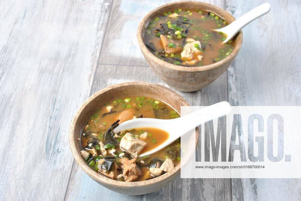 Japanese miso soup with fresh tuna, dried seaweed, tofu, shiitake dried mushrooms in a wooden bowl on the wooden background, Japanese miso soup with fresh tuna, dried seaweed, tofu, shiitake dried mushrooms in a wooden bowl on the wooden background, 30.03.2021,