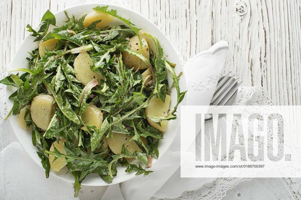 Dandelion salad, Healthy dandelion salad with potatoes on wooden background close up, 30.03.2021,