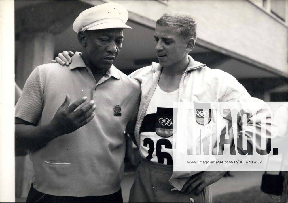 Champions Past And present. Jesse Owens And Armin Hary. World famous athlete Jesse Owens who is now in Rome with members of the American Team - was to be seen this morning at the Olympic Village where he talked with Armin Hary the German sprinter who yesterday won the Gold Medal for winning the 100 Metres dash - in 10.2 which equals his own 10.2 Olympic Record - set up in a heat the previous day. Photo Shows:- Jesse Owens and Armin Hary - when they met in the Village this morning. - ZUMAk09