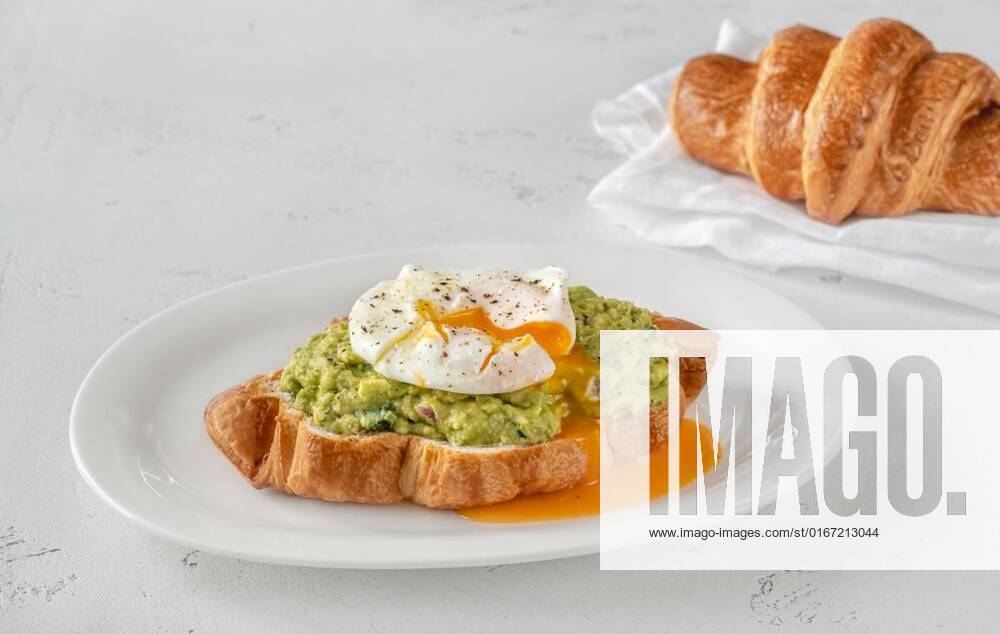 Croissant with guacamole and poached egg, Croissant with guacamole and poached egg on the serving plate, 06.08.2021,