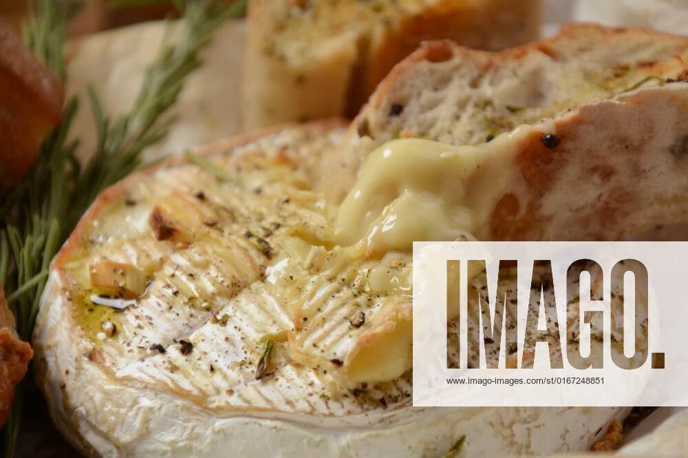 Baked camembert with toasts , rosemary on white cooking paper, Baked camembert with toasts , rosemary on white cooking paper, 14.08.2021,
