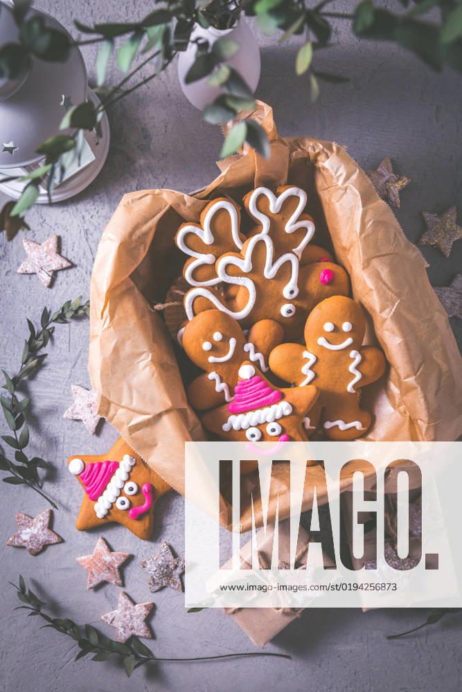 Gingerbread cookies for Christmas in cookie box with stars and small presents Gingerbread cookies for Christmas in cookie box with stars and small presents