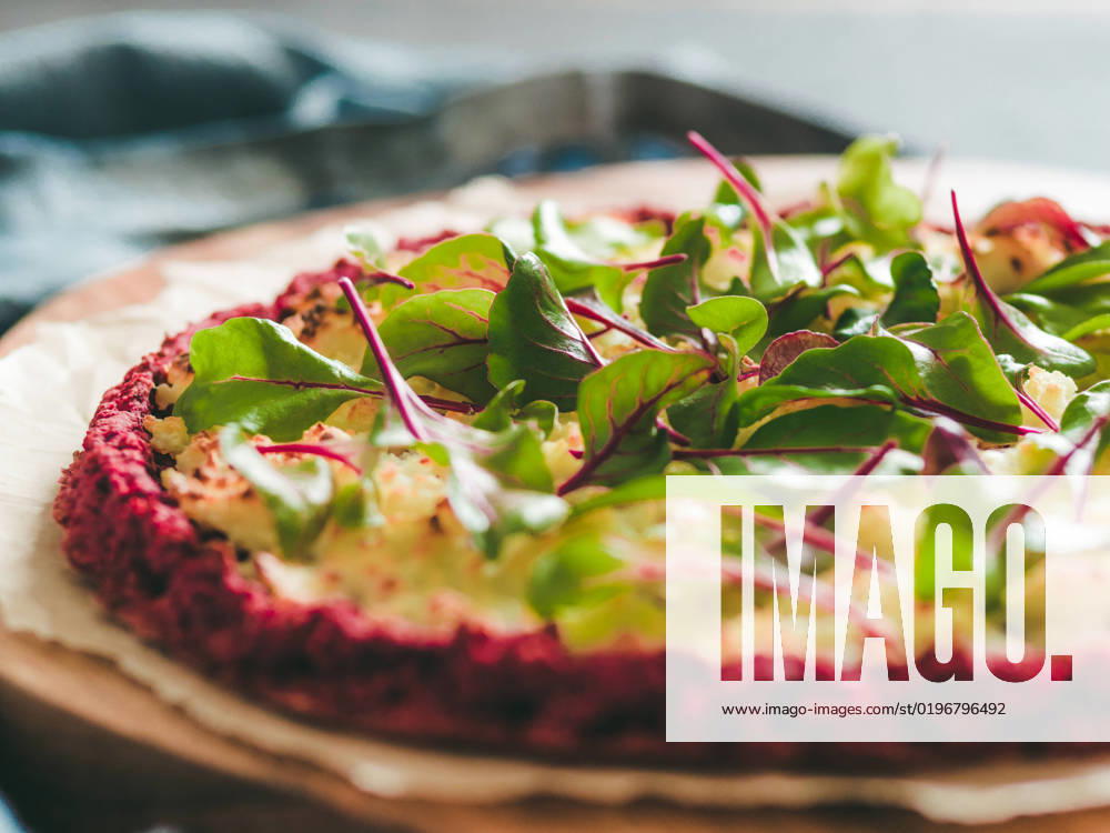 Beetroot pizza crust with fresh mangold leaves beetroot pizza crust with fresh swiss chard or mangold, beetroot leaves. Ideas and recipes for vegan snack.Egg-free pizza crust with chia seeds and wholegrain brown rice flour. Copy space. Shallow DOF
