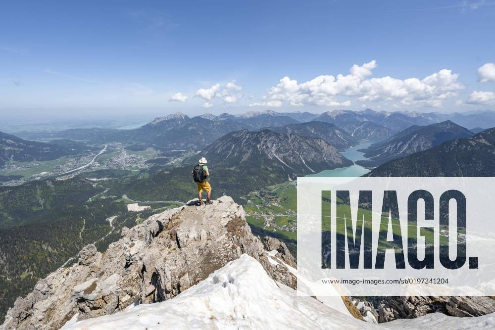 Hikers on Summit of thaneller, Outlook at Mountains with Plansee and Place reutte, mountain landscape, Lechtaler Alps, Tyrol, Austria, Europe