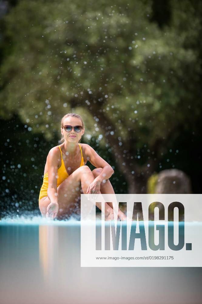 Young Beautiful Suntanned Woman wearing sunglasses relaxing next to a Swimming Pool on a lovely Summer Day, Young Beautiful Suntanned Woman wearing sunglasses relaxing next to a Swimming Pool on a lovely Summer Day, Young Beautiful Suntanned Woman wearing sunglasses relaxing next to a Swimming Pool on a lovely Summer Day model released, Symbolfoto , 02.11.2022,